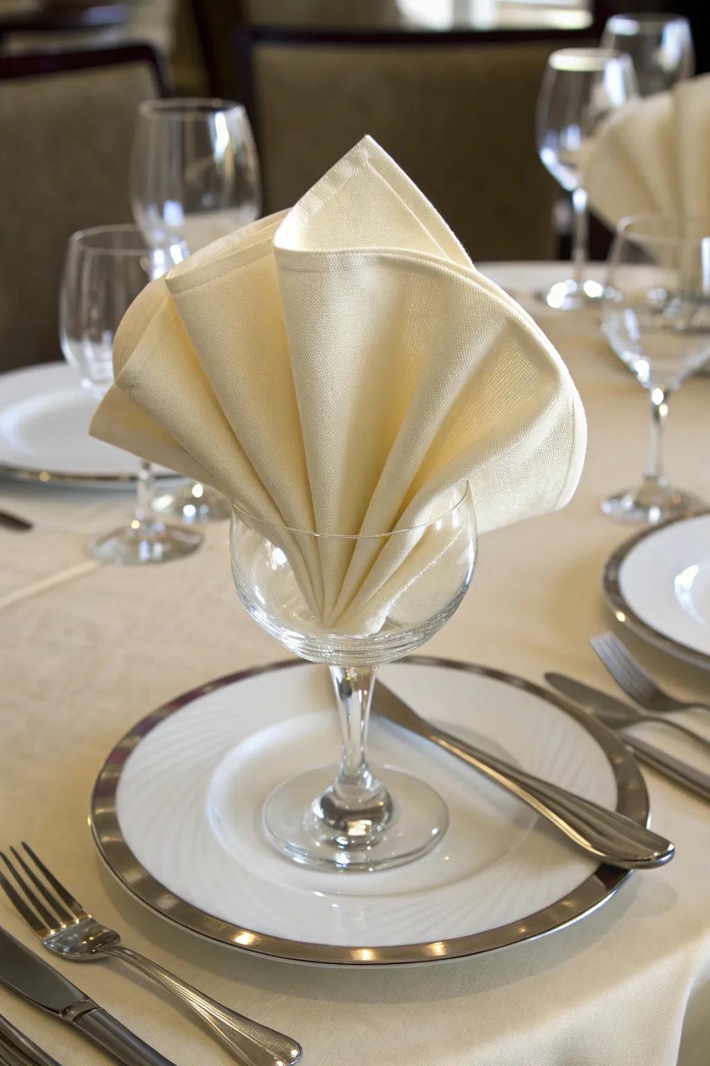 A silk napkin elegantly folded into a classic fan, adding sophistication to the table setting.