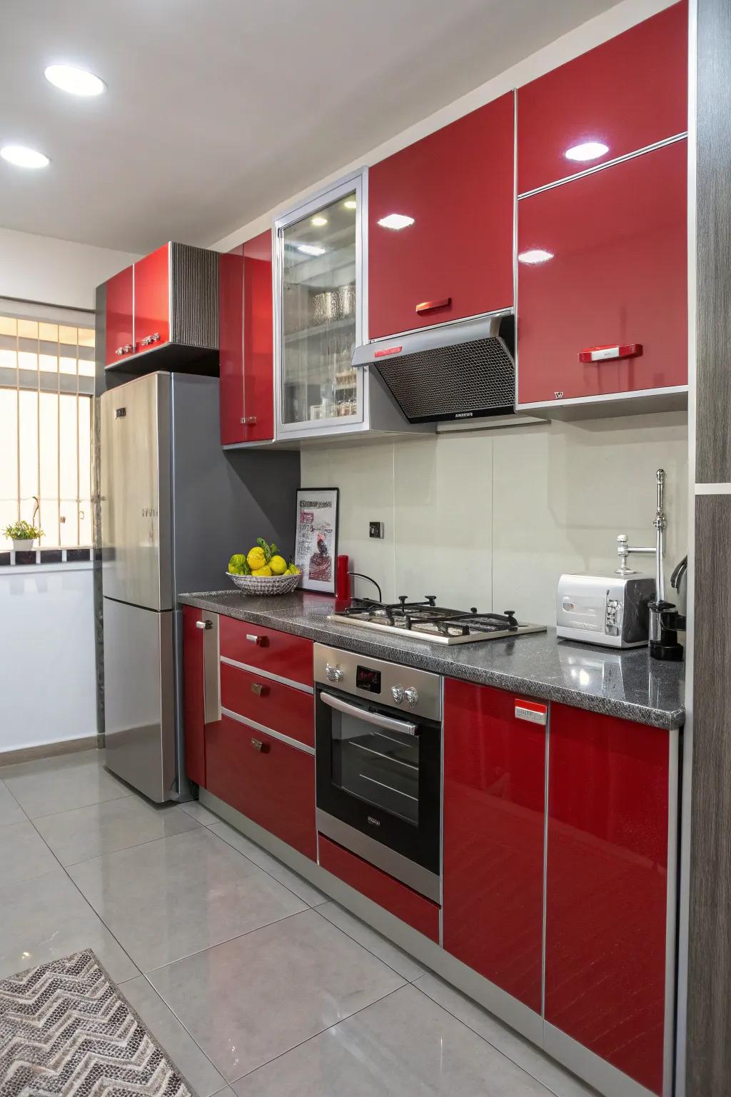 High-gloss red and grey cabinets reflecting light in a small kitchen.