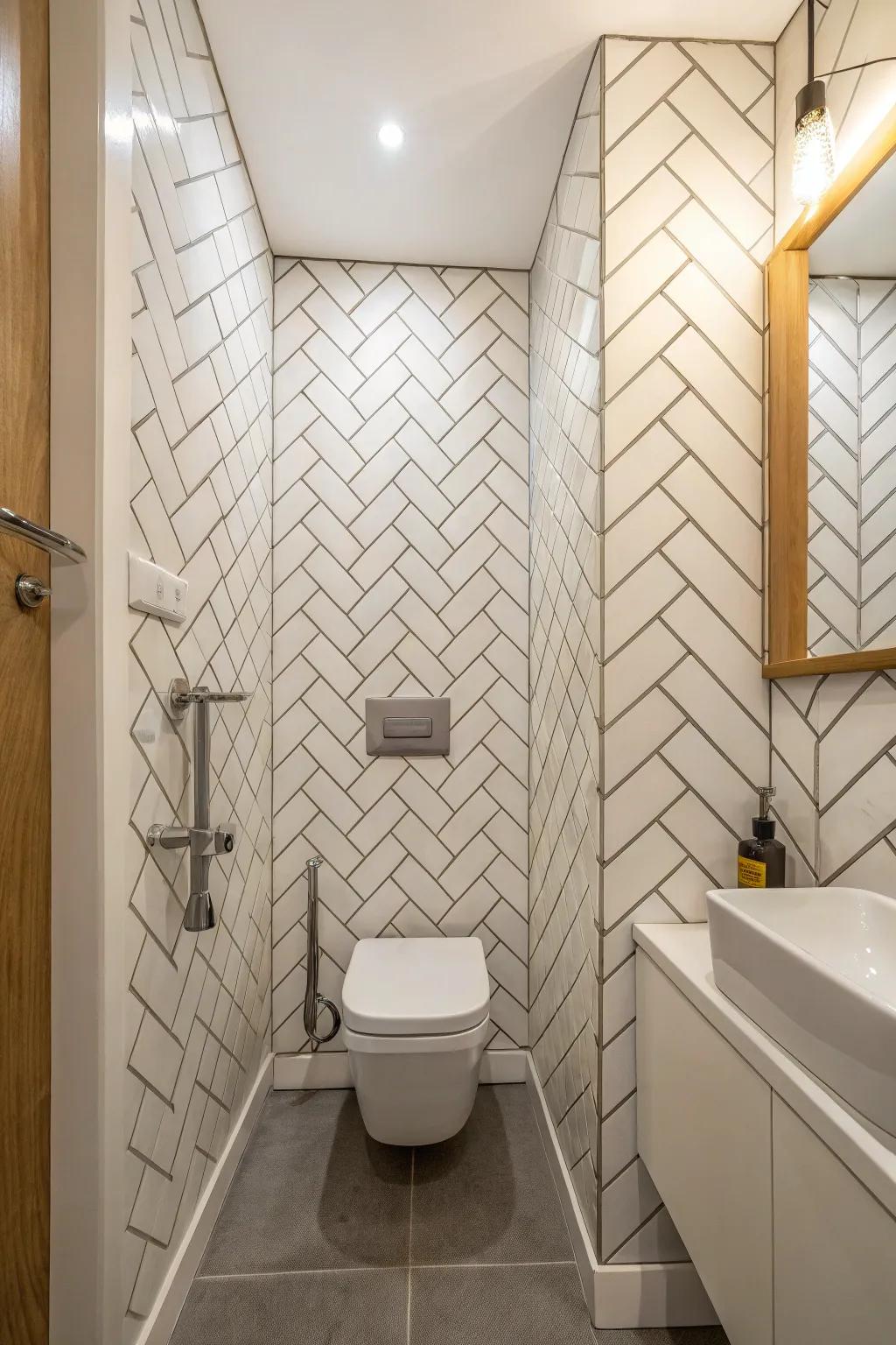 Vertical chevron tiles lift the eye, adding a sense of height and openness to this compact bathroom.