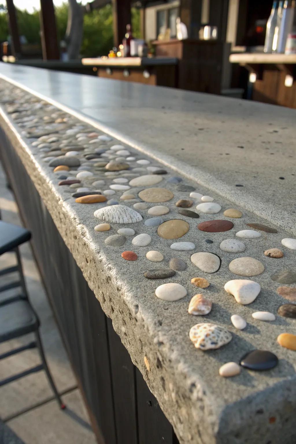 Craftsmanship meets artistry: A concrete bar top with exquisite pebble and shell inlays.