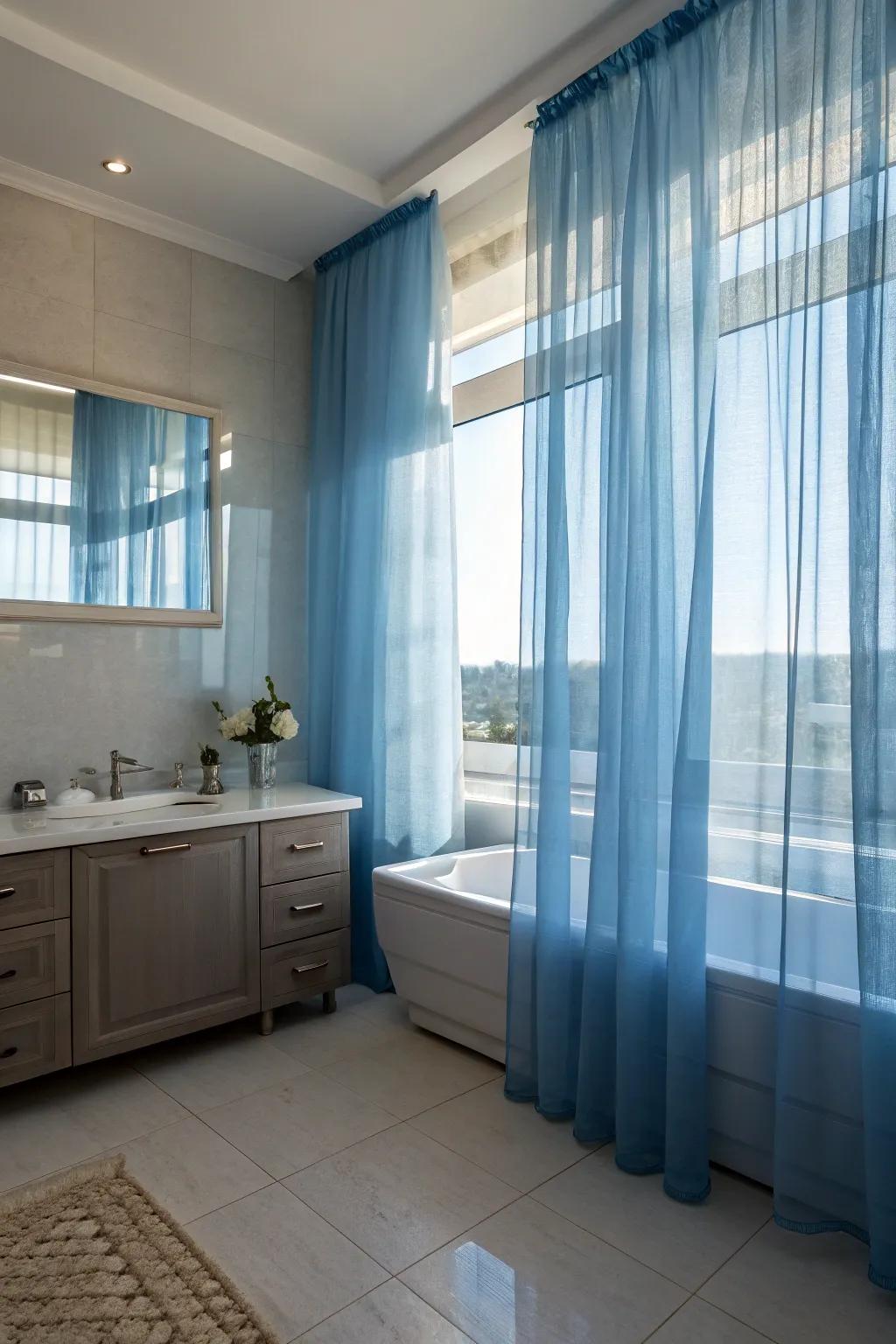 Sheer blue curtains offer privacy while creating a dreamy, ethereal ambiance.