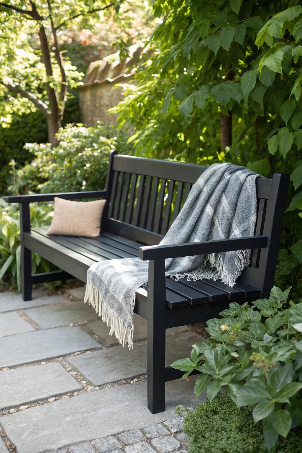 Embrace the elegance of monochrome with a chic black bench that stands out amidst the greenery. #ScandinavianStyle #MinimalistChic