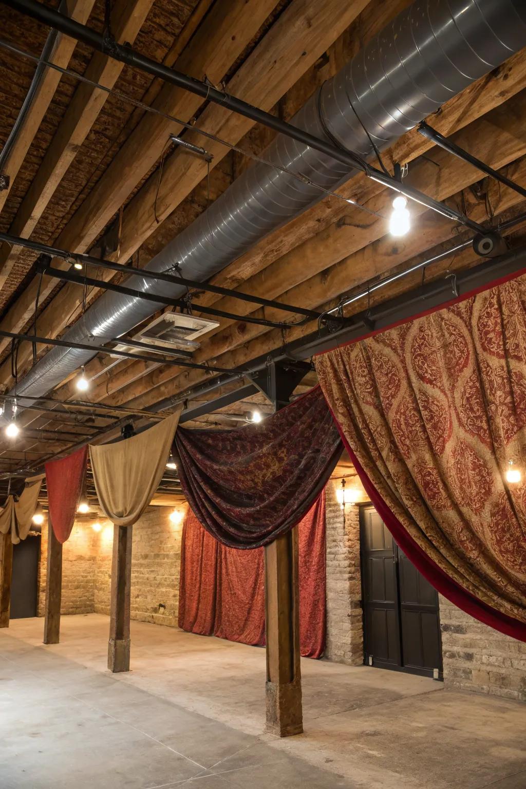 Transform your basement's industrial ceiling with elegant fabric panels for a warm, cozy touch.