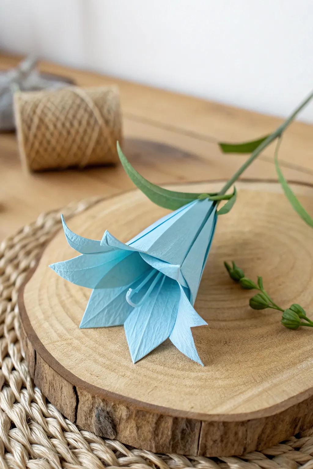 Embrace the charm of simplicity with this delicate origami bluebell, where minimalist design meets natural elegance.