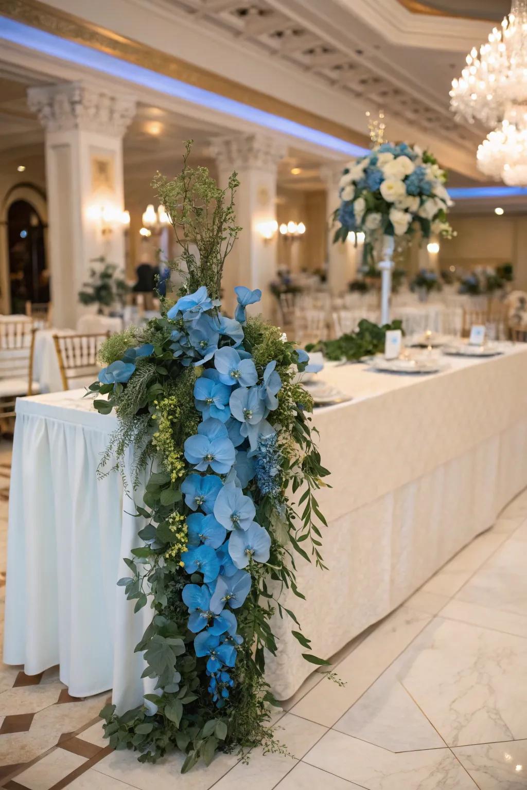 Luxurious garland with blue orchids and greenery.