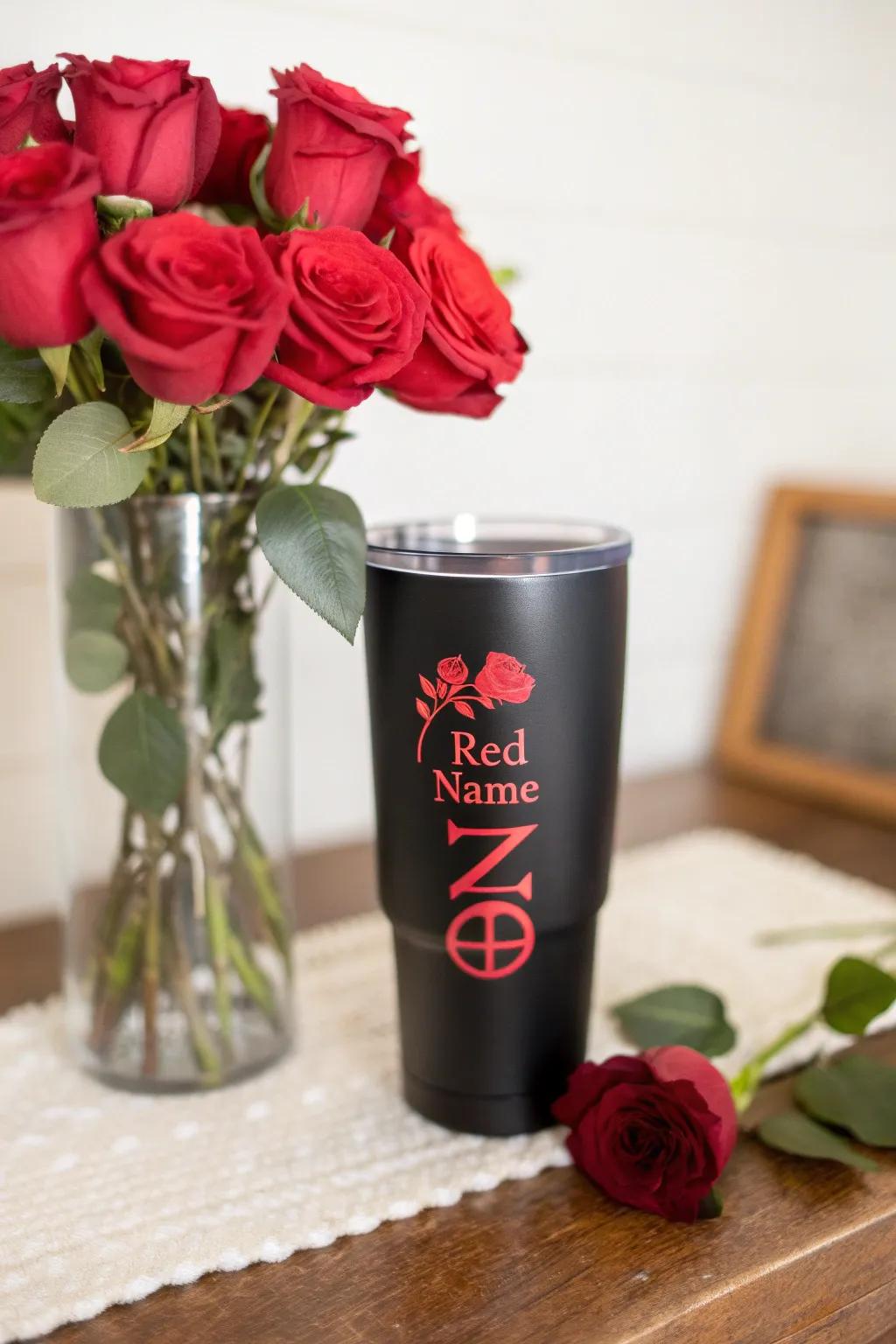 A personalized black tumbler with a striking red name.