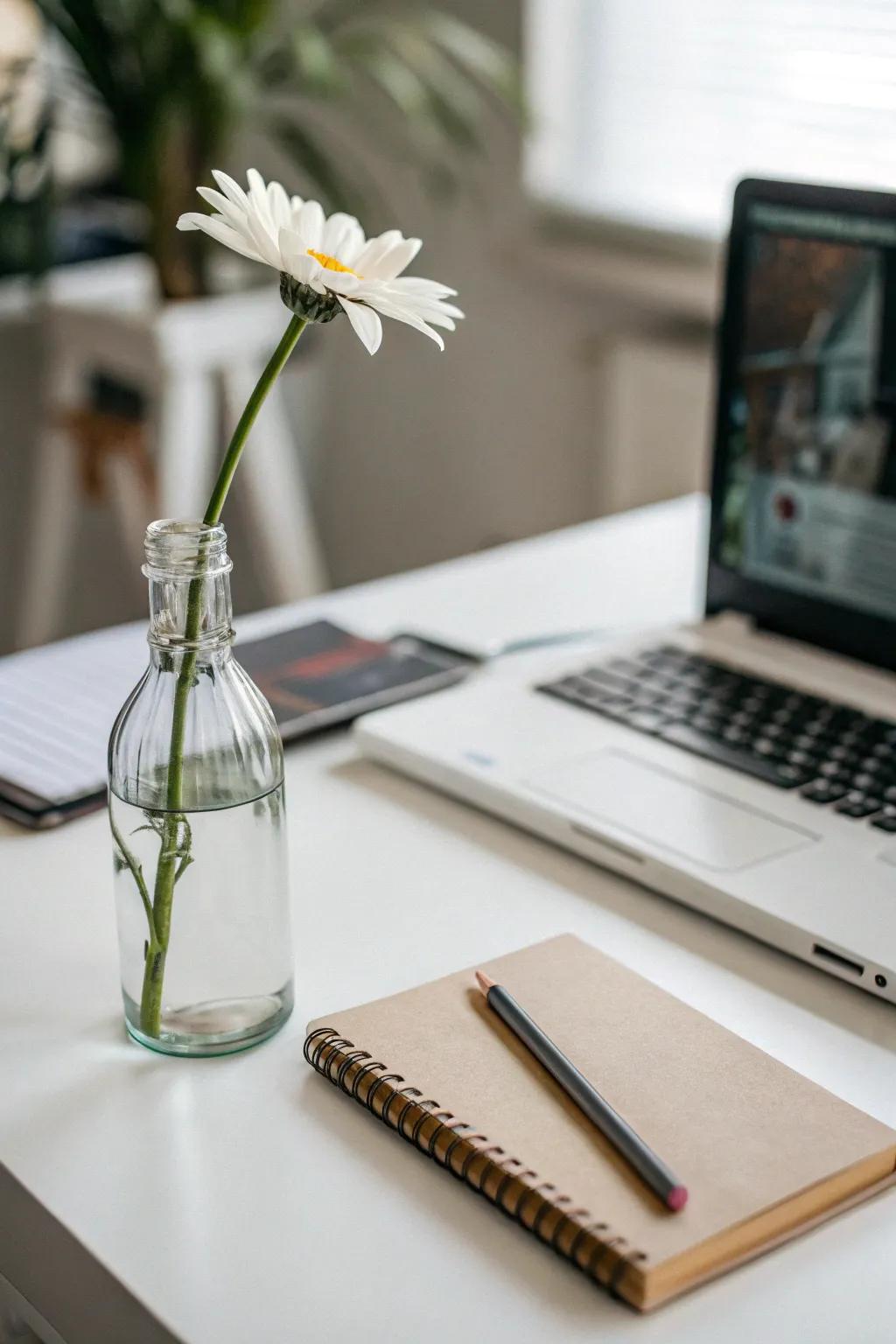 A single stem in a glass bottle offers minimalist elegance.