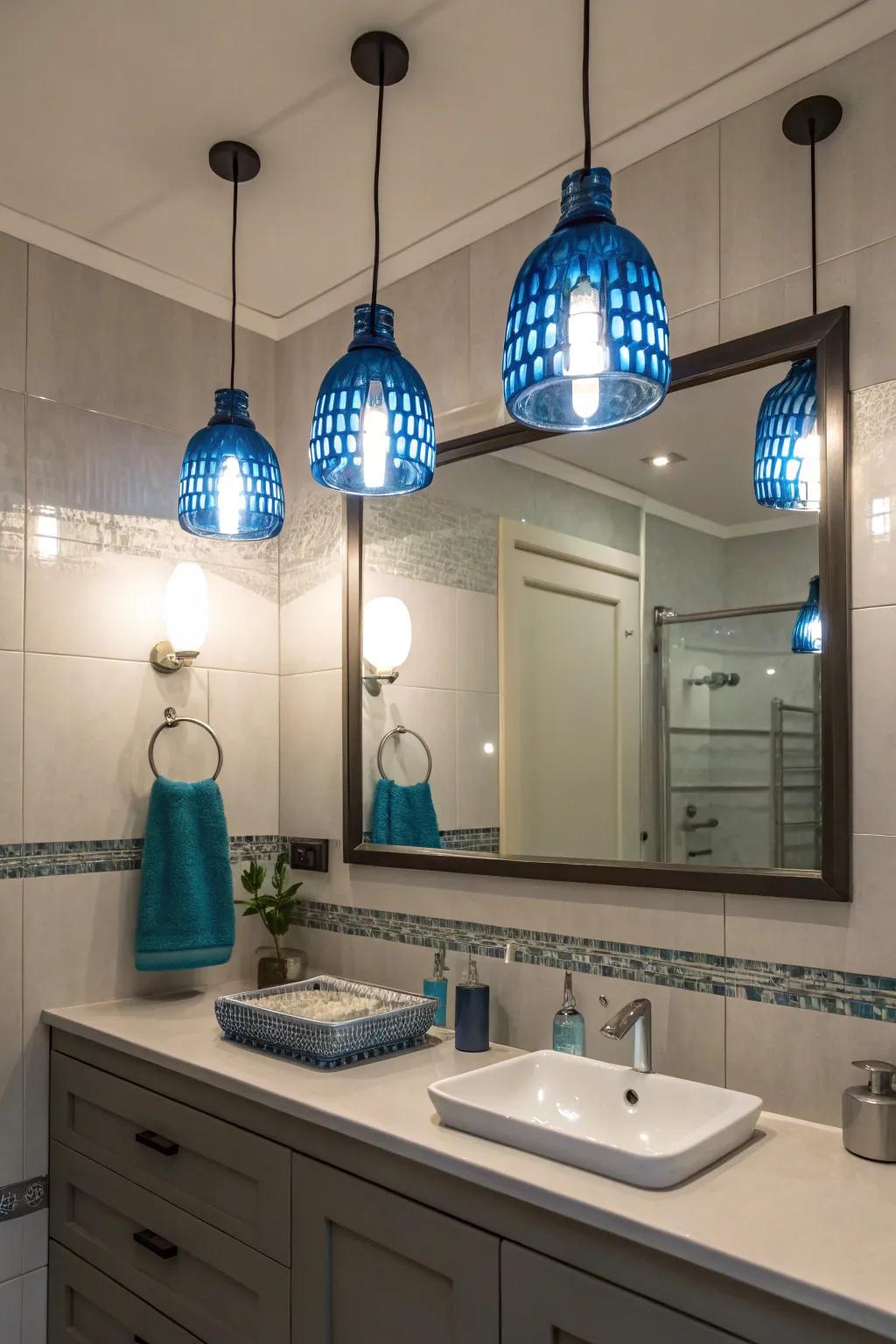 Blue pendant lights illuminate and add a touch of color to this chic bathroom.