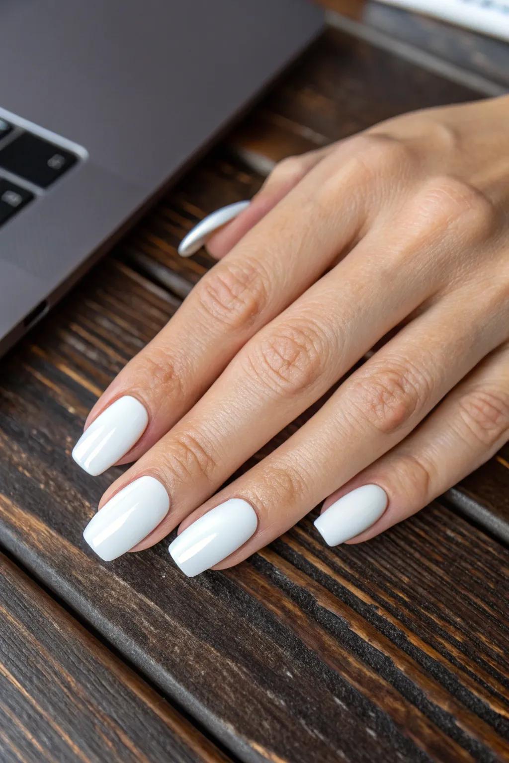 Embrace the art of simplicity with a glossy white manicure, where elegance meets craftsmanship.