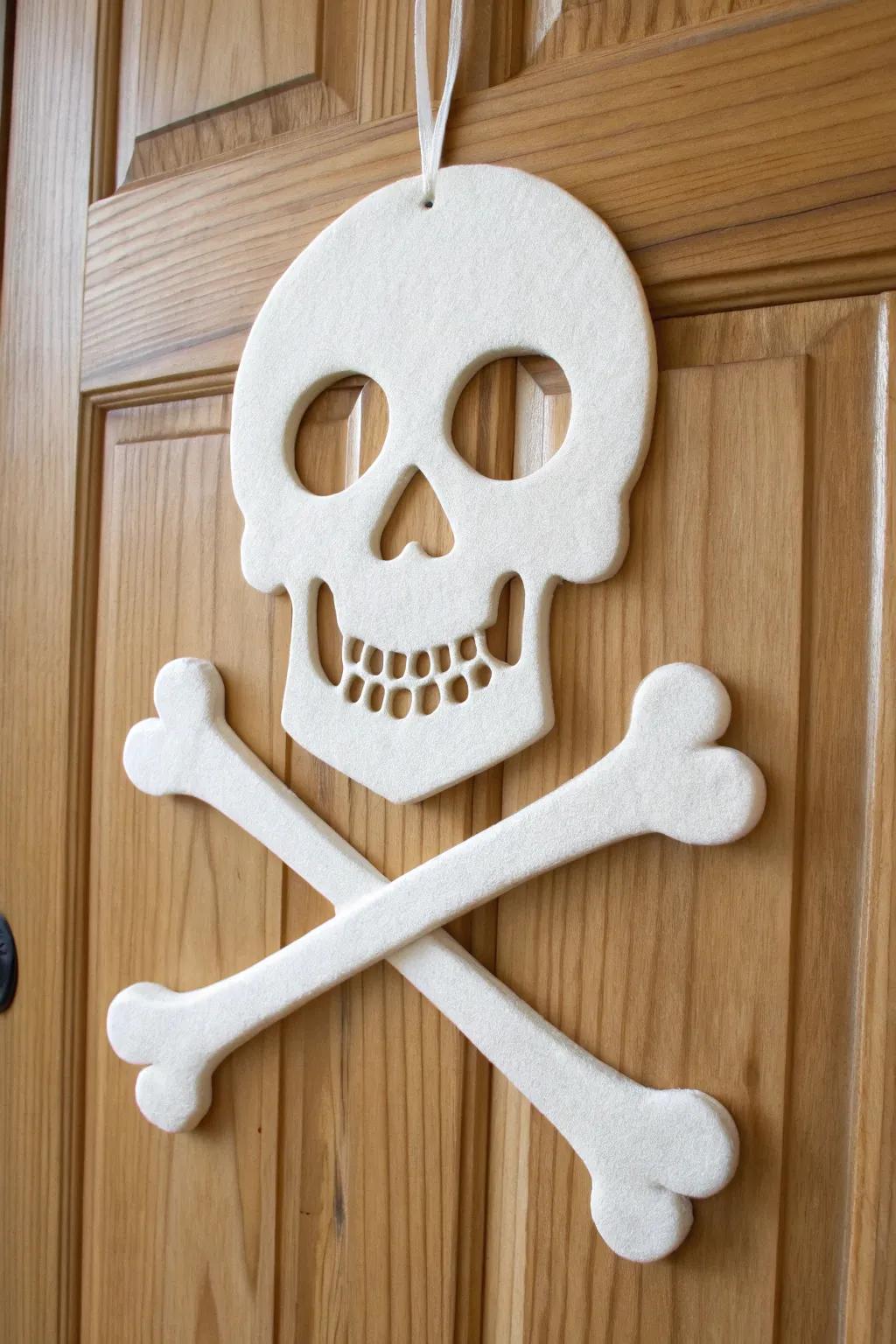Add a touch of minimalist pirate charm to your Halloween decor with this elegant skull and crossbones door hanger.