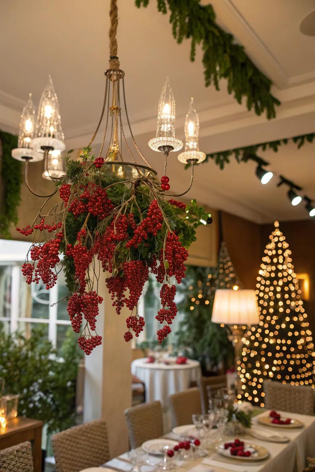 Red berries add a cheerful pop of color to chandelier decor.