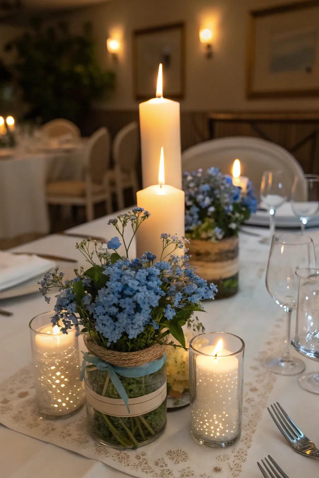 Romantic table decor with blue tweedia and candles.